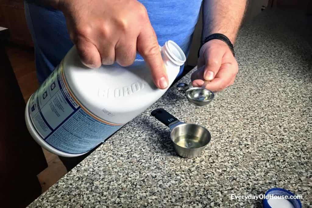 Measuring bleach to remove smells from rain barrel