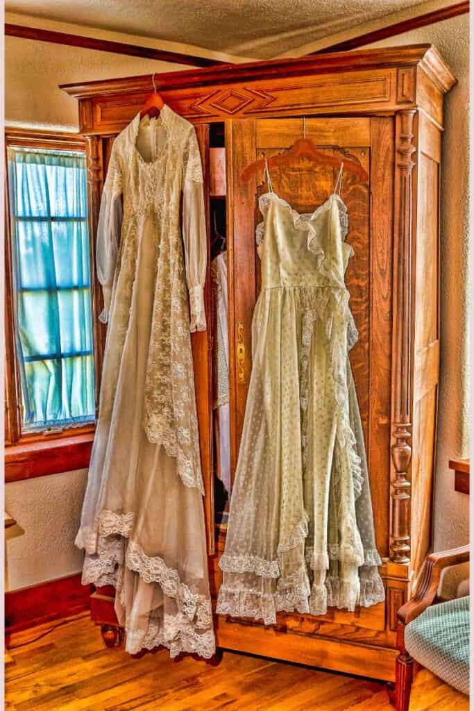 antique armoire with vintage womans dress in front