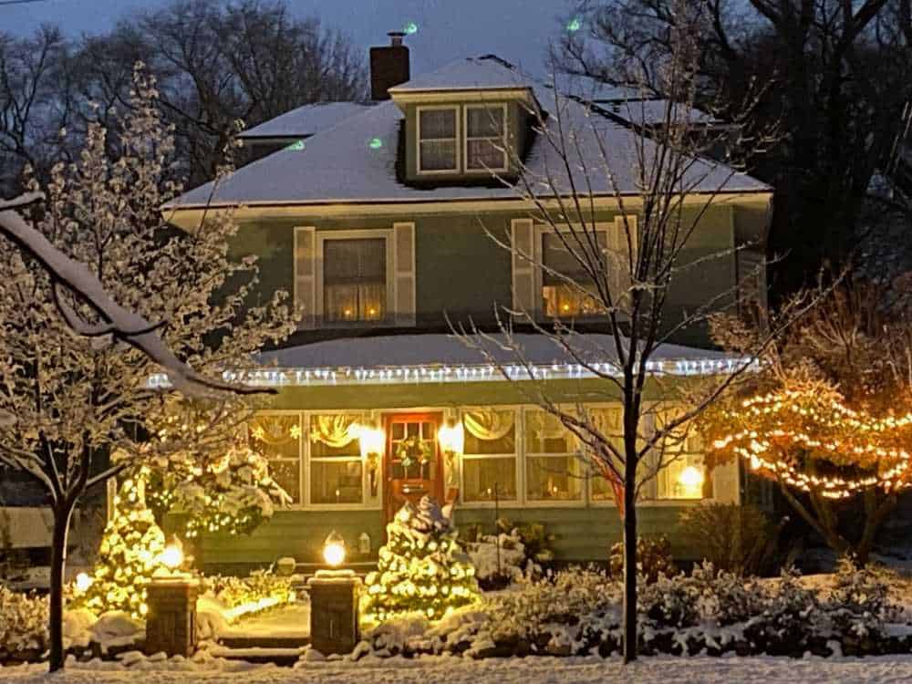 beautiful winter scene with american foursquare house B&B - Candlelite Inn - at dusk in snow.  Near Lake Michigan