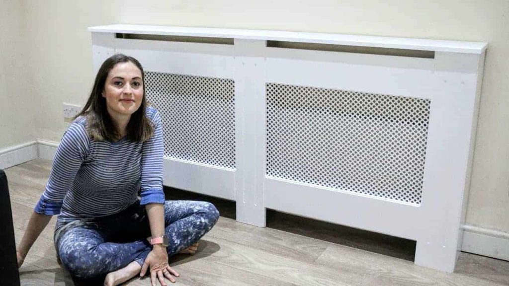 Woman sitting in front of DIY radiator cover