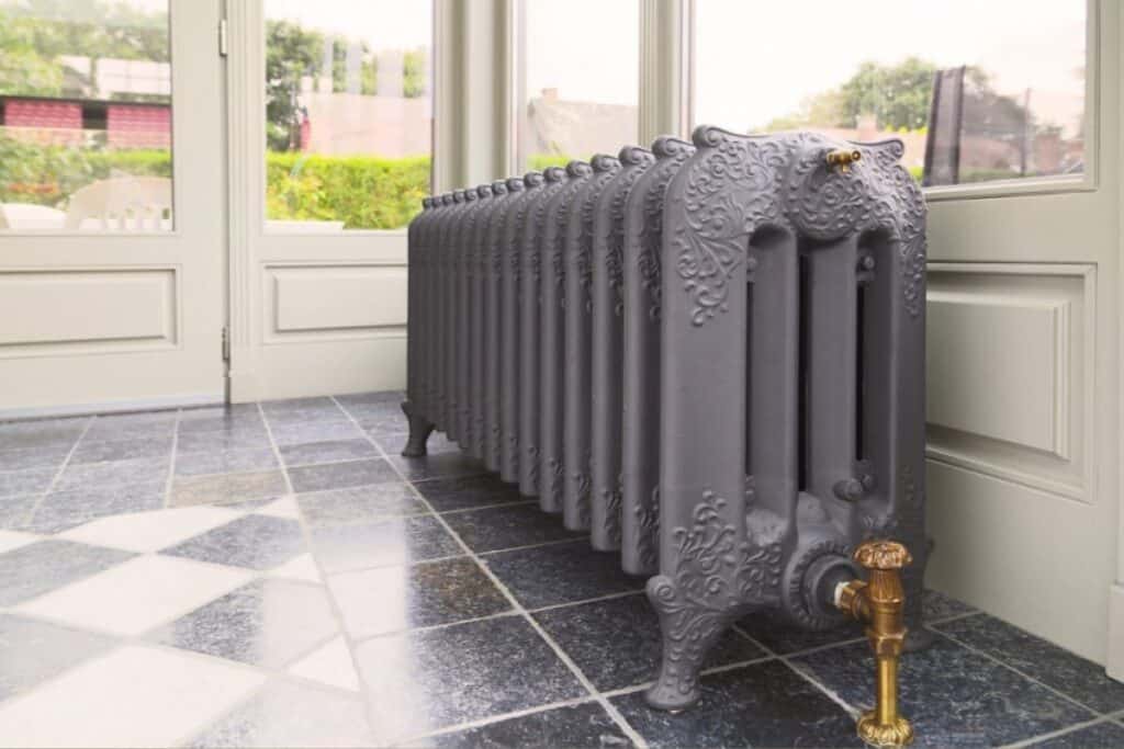 grey cast iron radiator in sunroom. gorgeous color
