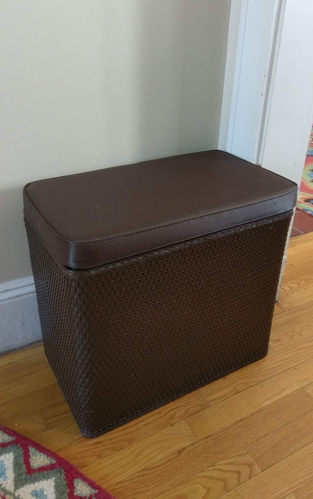 Looking for a laundry hamper that hides well with other furniture?  This one blends well with our leather couch on our first floor.  #hiddenlaundry #wovenlaundryhamper