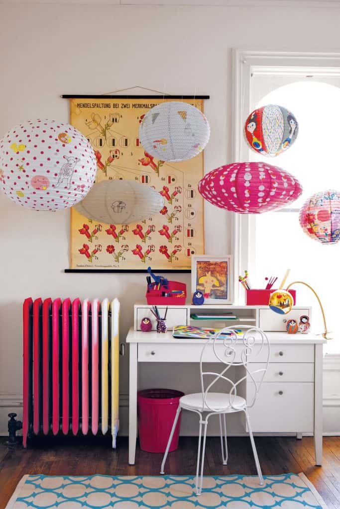 Beautiful pink, yellow and white room with multi-colored cast iron radiator in Land of Nod catalog via Redbook.com#olditnewagain #pinkradiator