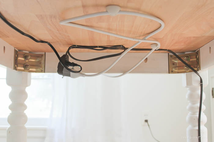 How to hide electrical cords behind table by LoveGrowsWild.com #organizehouse