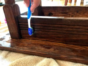 Cleaning built-up grime from wooden furniture with Murphy's Oil Soap and toothbrush #furniturerestorationhacks #murphysoilsoap #cleanwoodfurniture