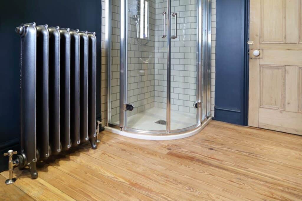 rich, gorgeous navy blue radiator that matches wall color in bathroom