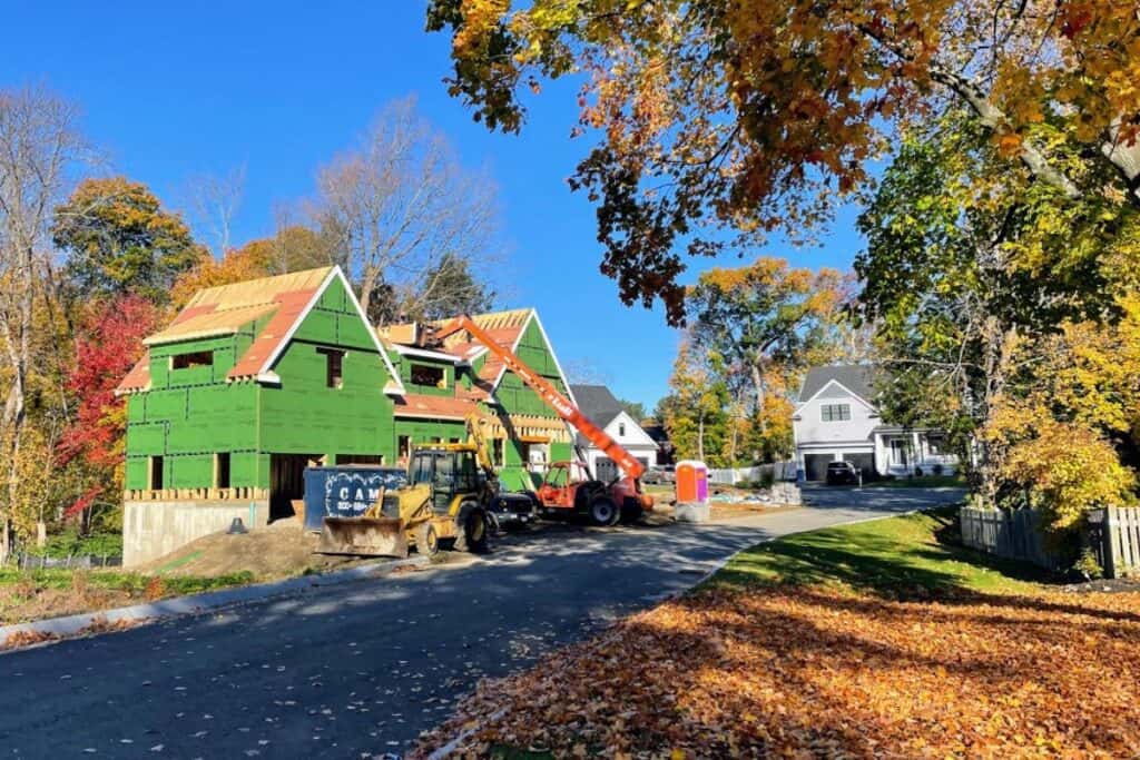 3 newly built houses squeezed on suburban lot where one old houses once stood