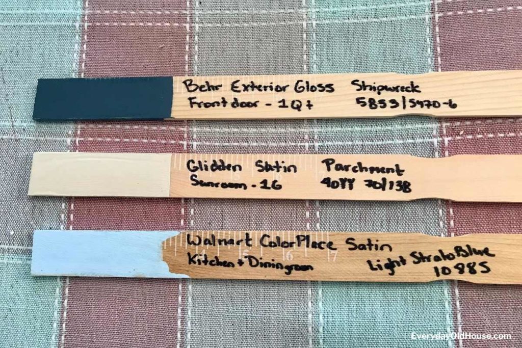 3 paint stirrers with paint dipped in one end and color paint hue, sheen and manufacturer code in other