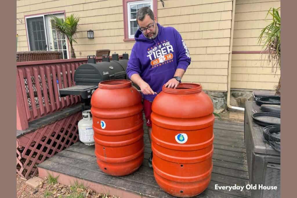 homeowner removing parts to rain barrel in order to prep for winter storage