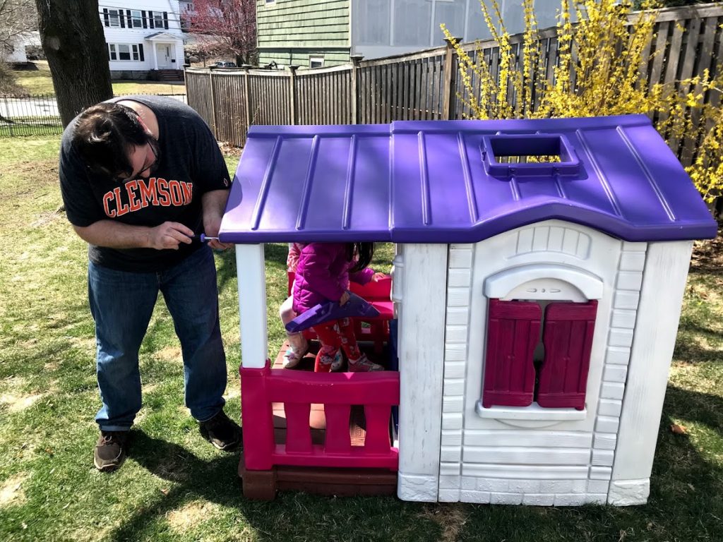 Reassembling the Step2 plastic playhouse after spray painting with Rust-oleum Painter's Touch 2x spray paint #rustoleum #diyprojects #kidsjustwanttohelp
