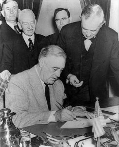 Connally (next to Roosevelt) holding a watch to fix the exact time of the declaration of war against Germany
