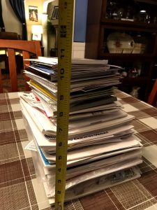 Stack of user manuals for about 100-125 items, measuring almost a foot high #userguides #homeguides