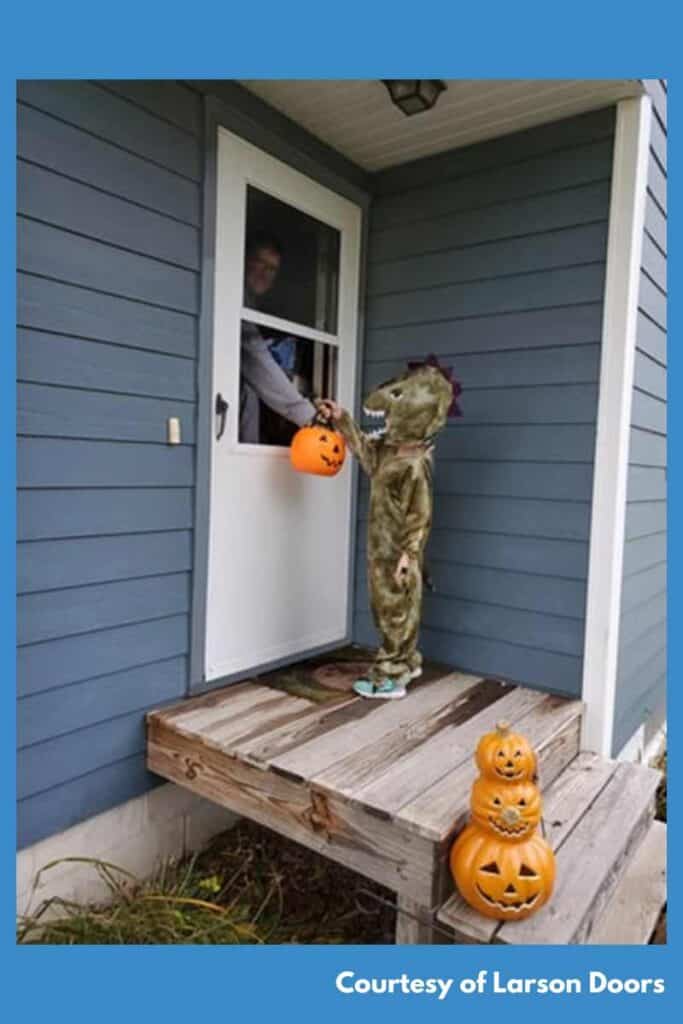 tricker-or-treater received candy from homeowner who popped off screen or glass panel from storm door to make it easier.  courtesy of Larson doors