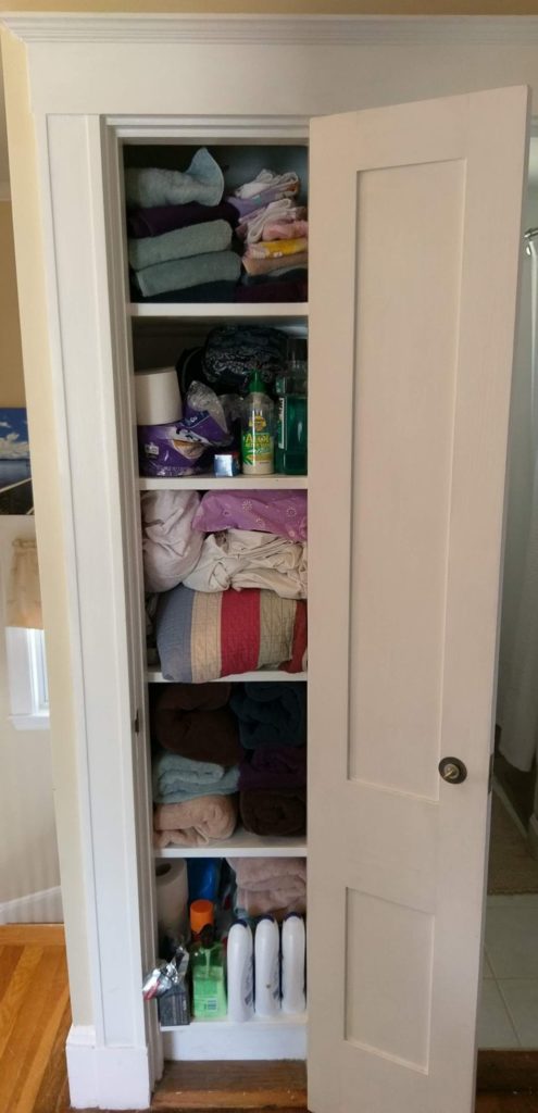 Before pic of my tiny linen closet. Towels shoved here, toiletries shoved everywhere. Using a easy-to-use checklist and inventory, I was able to completely reorganize into a functional and efficient linen closet for my family #declutterchecklist #declutterinventory