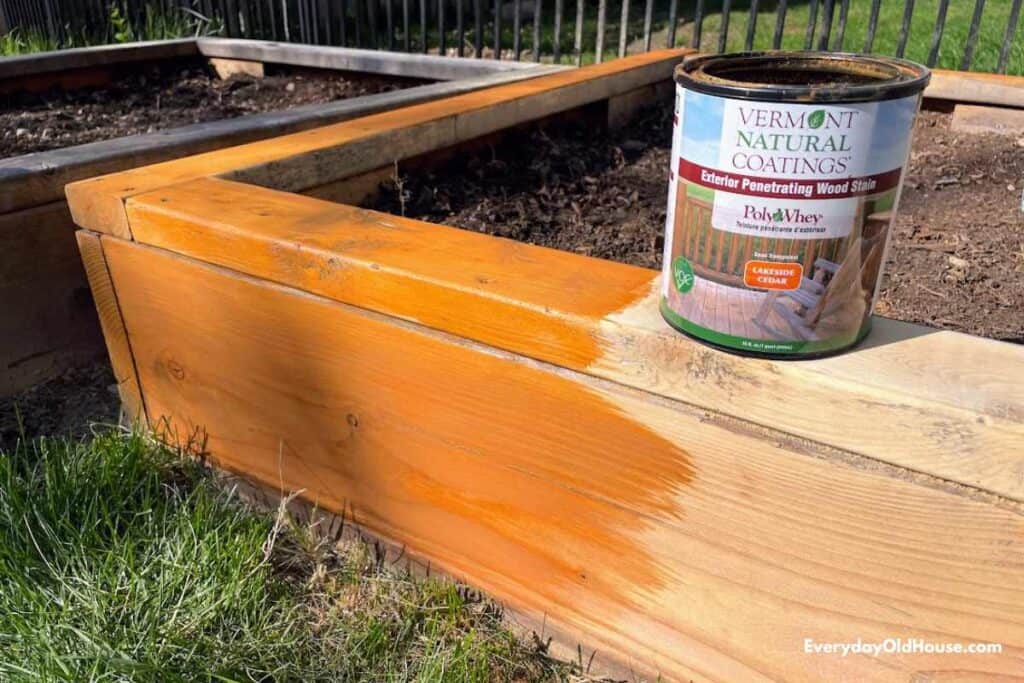 showing stain on Vermont Natural Coatings (Lakeside Cedar) to revive the wood on raised vegetable garden bed