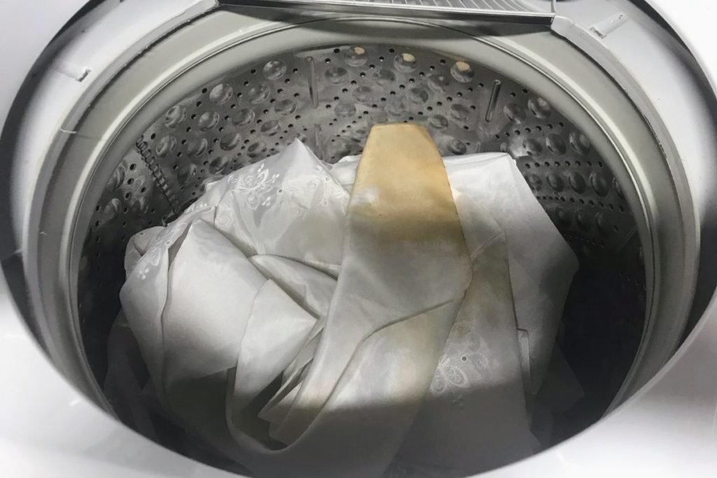 Vintage white sheers in washer to remove stains