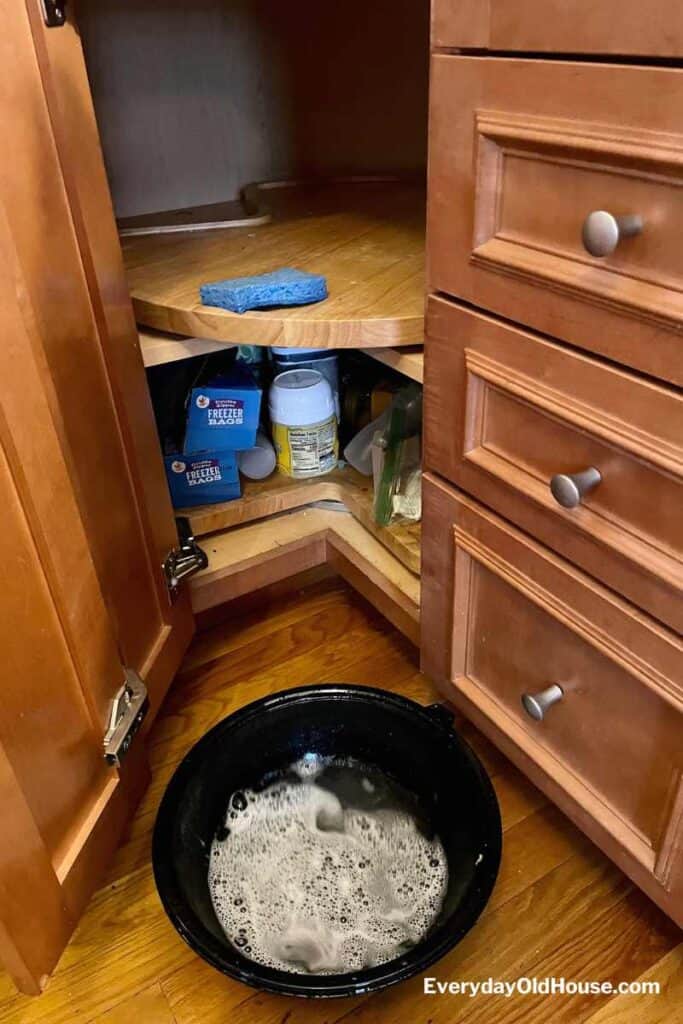 lazy susan in kitchen cabinet getting s scrub with warm sudsy water