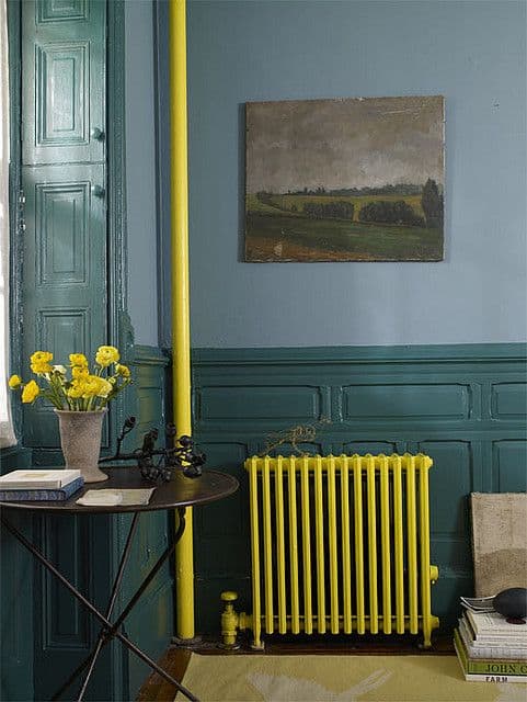 Pop of yellow painted on cast iron radiator and pipe feed #paintideas #DIYpaintradiator