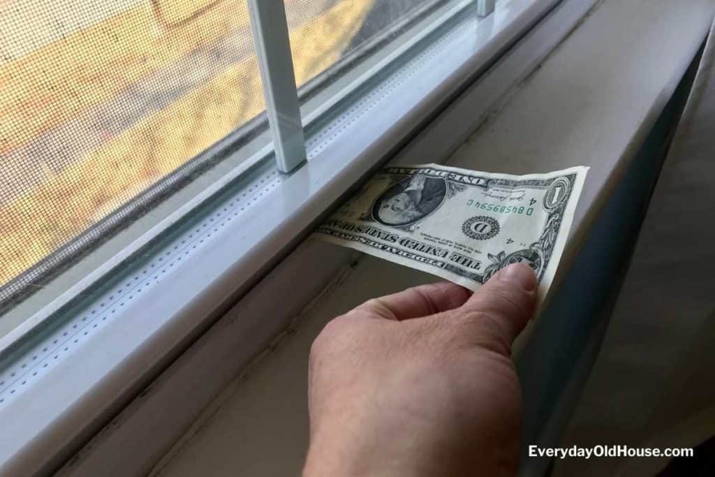 Dollar bill in window sill to be pulled to test energy efficiency