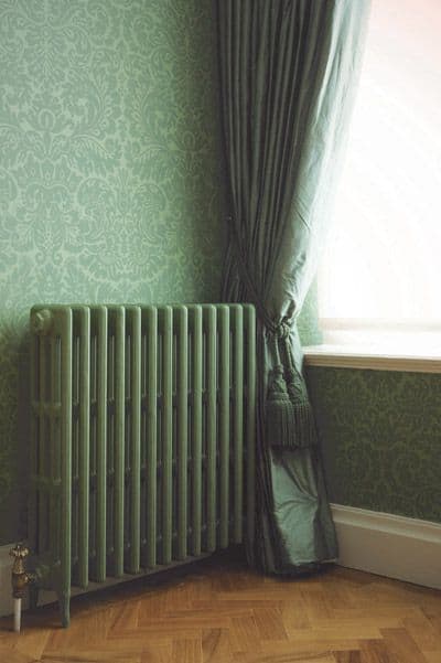 Green cast iron radiator blends with traditional wallpaper #greenwall #sagegreendecor