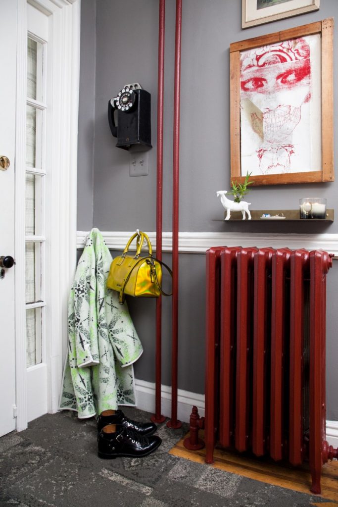 Red cast iron radiator on viewed on Domino.com with source of Gunnar Larson for Home Polish #castironradiator #radiatorpaint