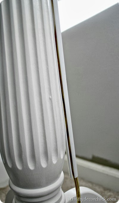Table leg with cord conduit attached to hide electrical cord. image courtesy of thriftydecorchick
