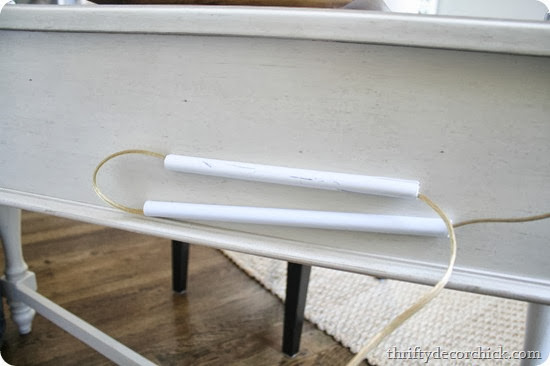 Deck with cords hidden using cord conduits with adhesive tape. image courtesy of thifty decor chick